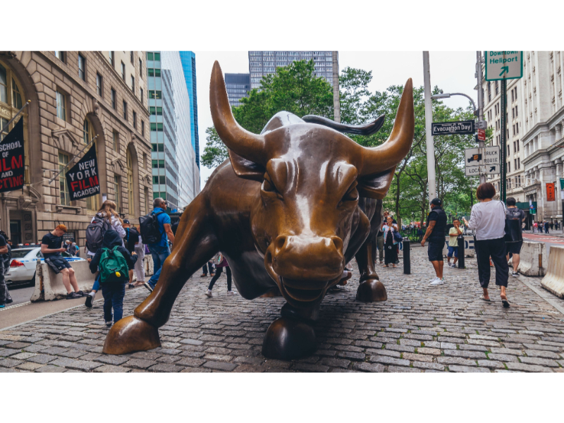 Charging Bull statue on Wall Street in Times Square New York with tourists taking photos