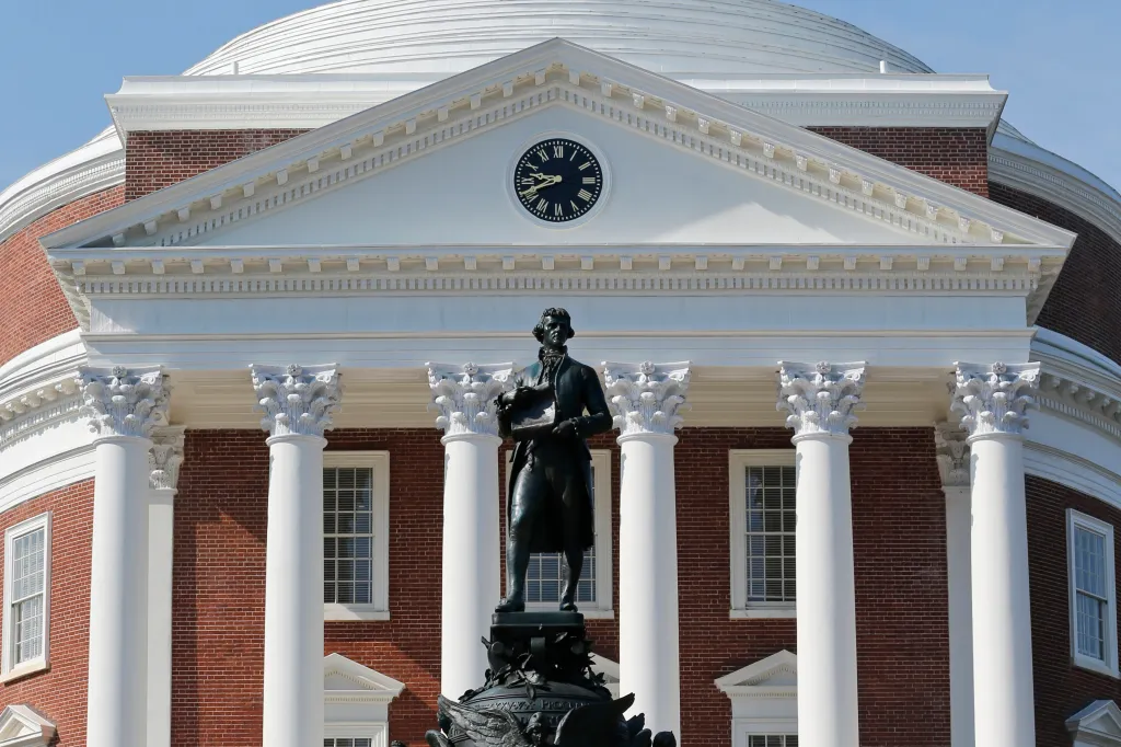 Statue of Thomas Jefferson in front of the Rotunda at the University of Virginia, featuring neoclassical architecture and iconic white columns.