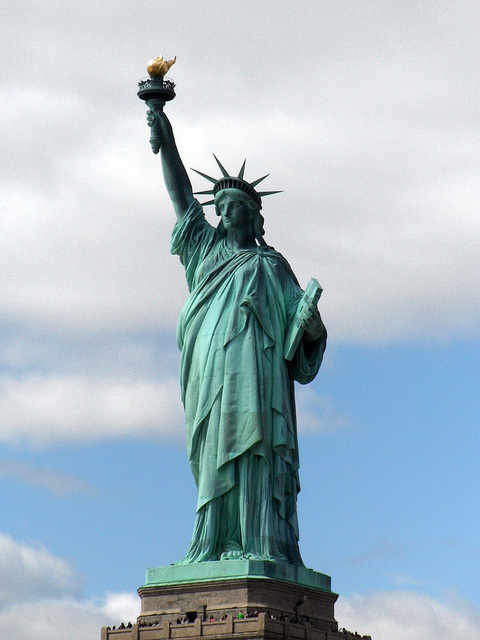 Statue of Liberty standing tall on Liberty Island in New York Harbor, symbolizing freedom and democracy in the United States