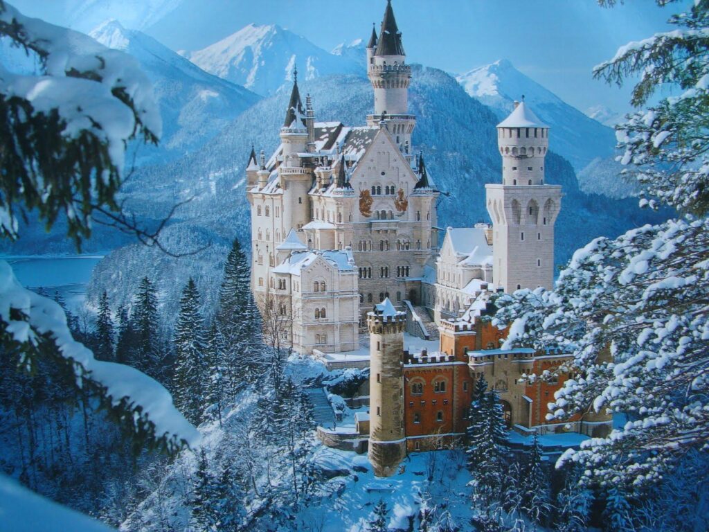 Neuschwanstein Castle travel guide: "Neuschwanstein Castle in Bavaria, Germany covered in snow during winter, surrounded by alpine mountains and evergreen forests"