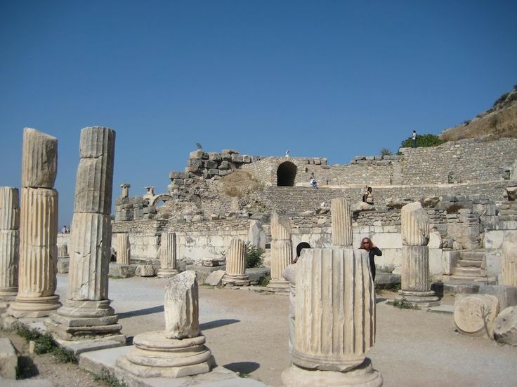 "Ancient stone columns and ruins of Ephesus in Turkey under a clear blue sky, showcasing remnants of Roman architecture and history"