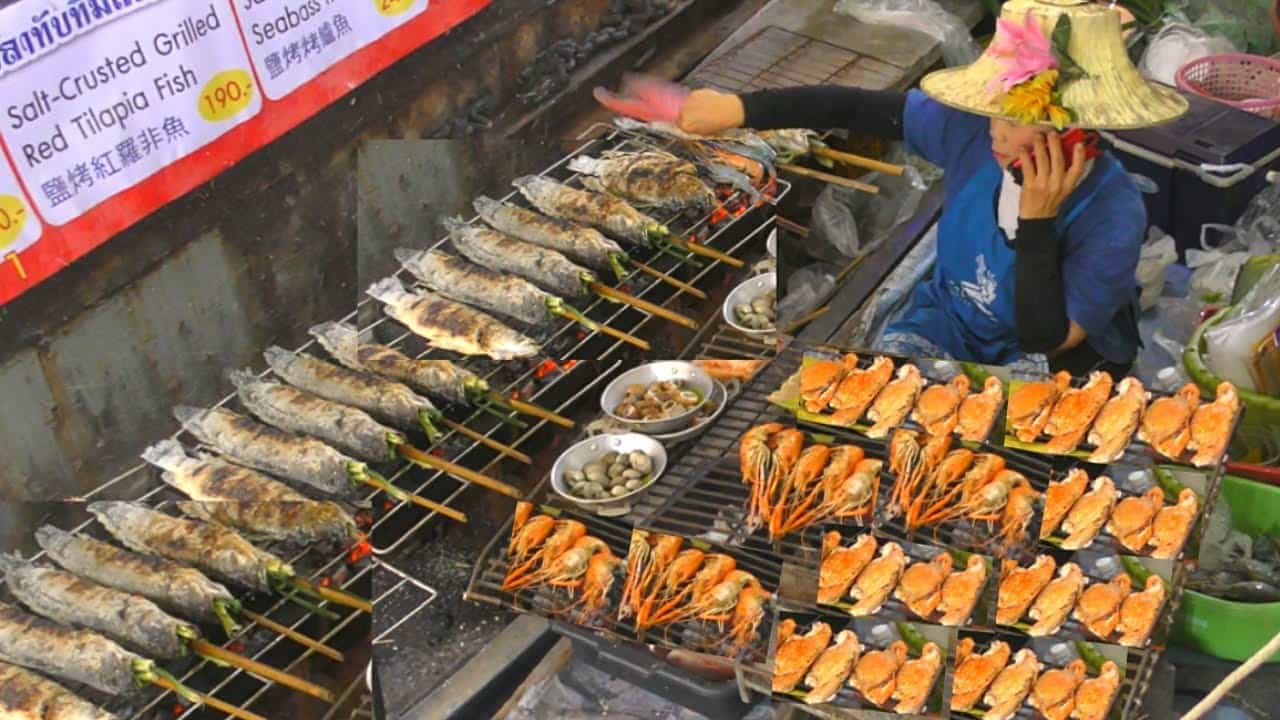 "Vendor grilling salt-crusted fish and seafood at a floating market in Thailand, showcasing authentic Thai street food culture"