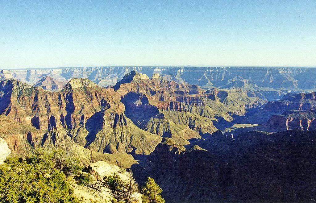 Copper Canyon Mexico "Panoramic view of the Grand Canyon’s colorful layered rock formations and deep valleys under a clear blue sky in Arizona, USA"