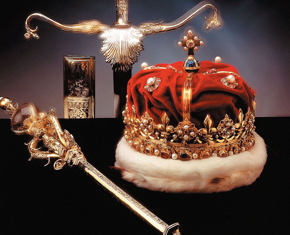 "The Scottish Crown Jewels displayed at Edinburgh Castle, featuring the royal crown, sceptre, and sword of state adorned with gold, pearls, and gemstones."