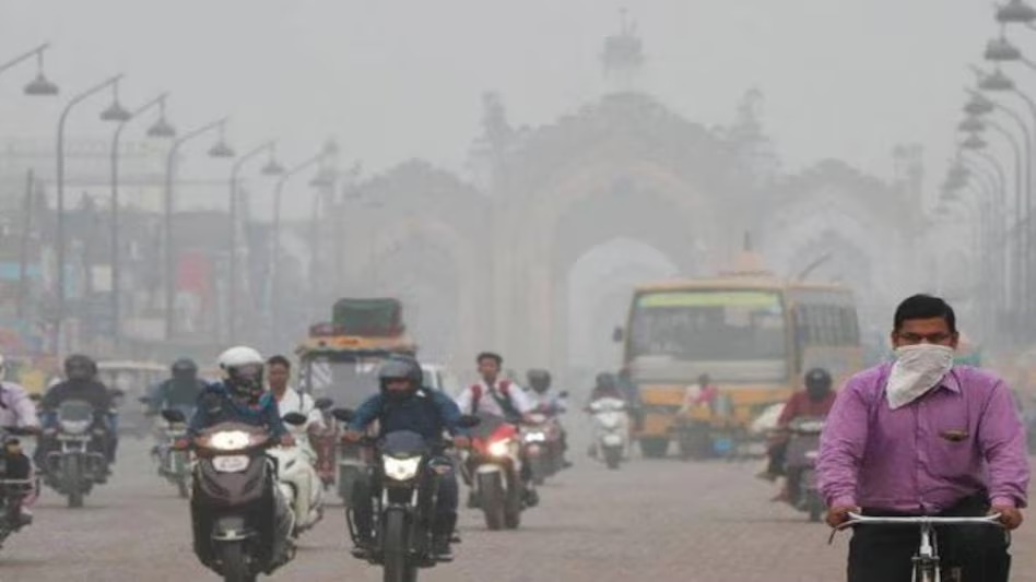 Delhi air quality crisis: Commuters wearing masks ride bikes and cycles through dense smog in Delhi, as air pollution reduces visibility and worsens health conditions across the city.