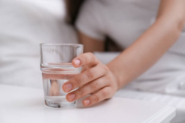 Morning Habits A glass of water on a bedside table